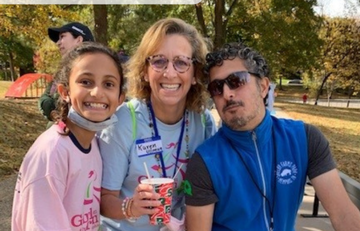 The Pai family poses and smiles at a 5K event.